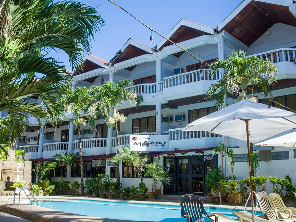 Boracay Peninsula garden courtyard with umbrellas and palms